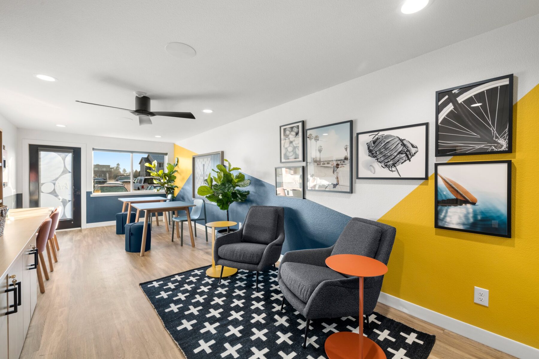 Kids club interior with desks and tables, coloring supplies and board games, comfy chairs