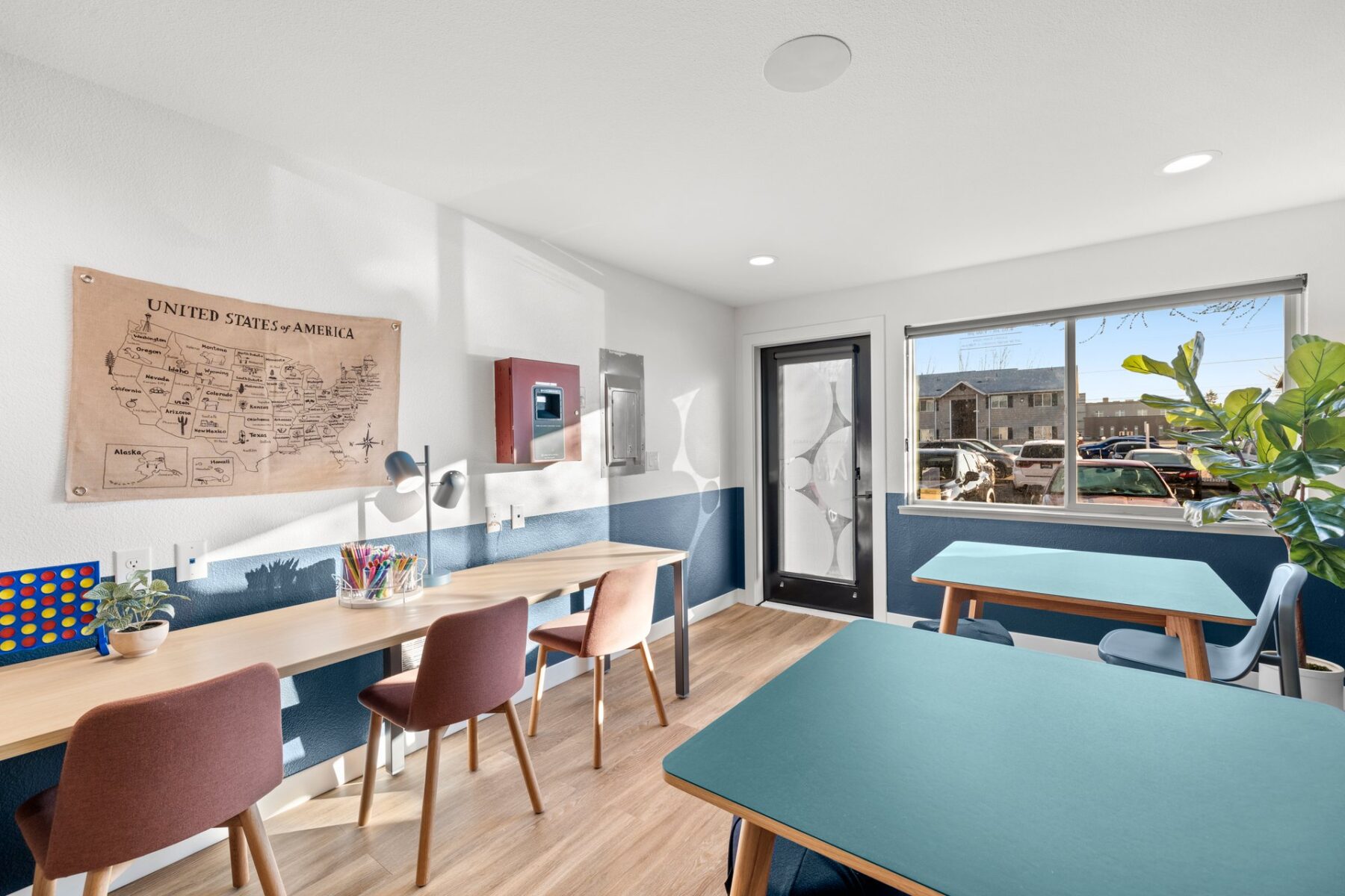 Kids club interior with desks and tables, coloring supplies and board games