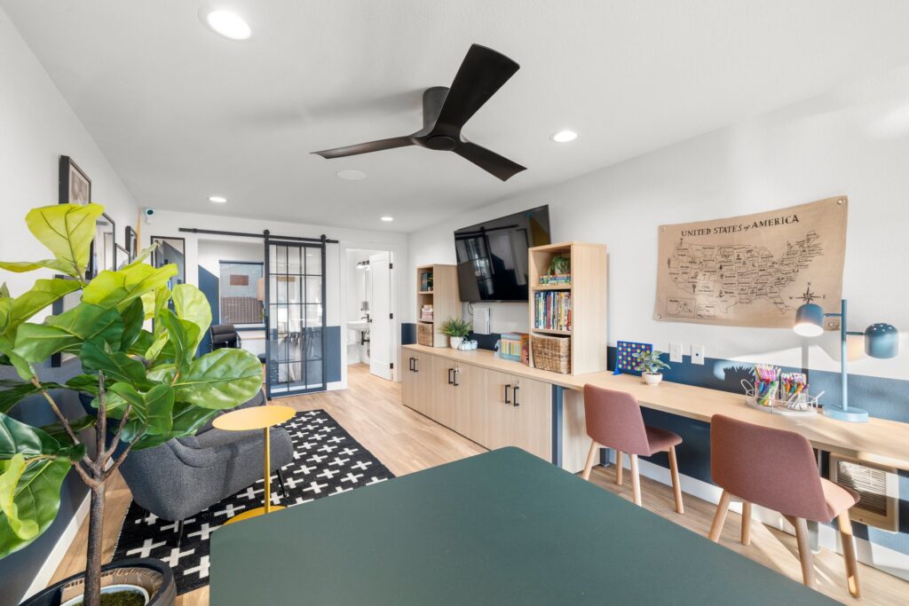 Kids club interior with desks and tables, coloring supplies and board games