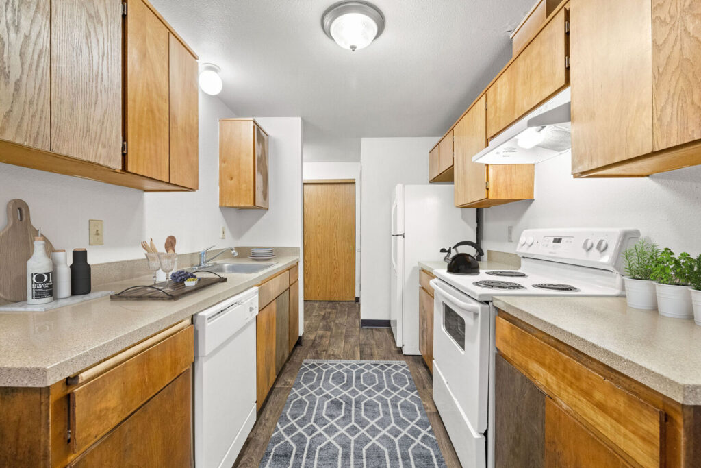 Kitchen with white appliances, wooden cabinets
