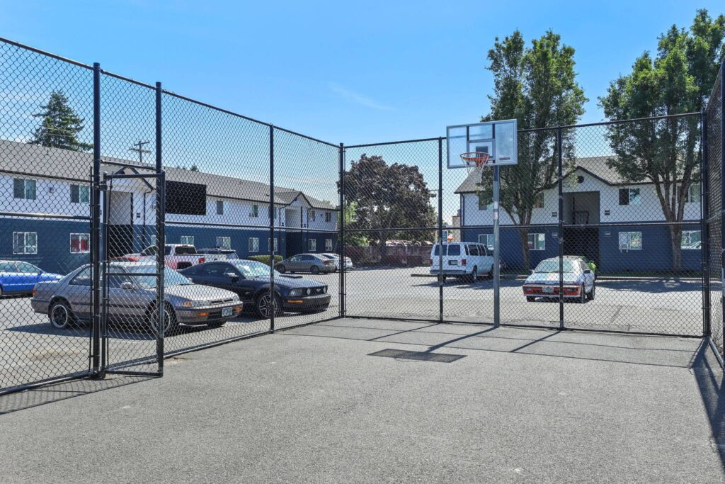 Basketball court in the center of a residential apartment parking lot.